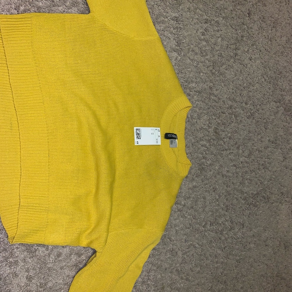 a yellow cropped sweater